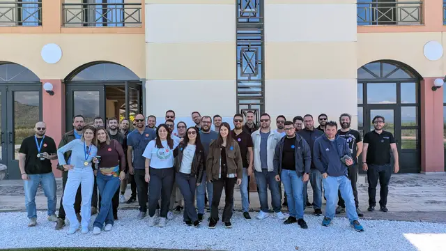 A large corporate group poses outside the venue after playing Black Out, a Salty Soil AR escape game