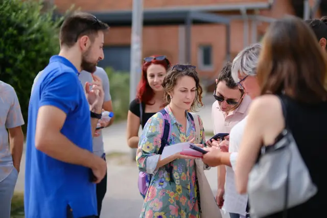 A team gathers around a clue sheet and a phone, working out the next stop during a Salty Soil city treasure hunt