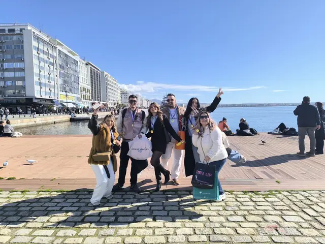 Winning team with medals celebrating on the Thessaloniki waterfront at the end of a Salty Soil city treasure hunt