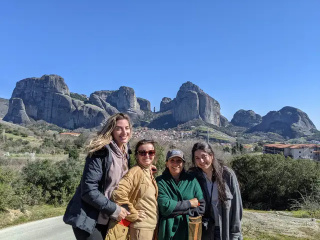 Four guests smile in front of the Meteora rocks and Kastraki village on a Salty Soil day trip from Thessaloniki