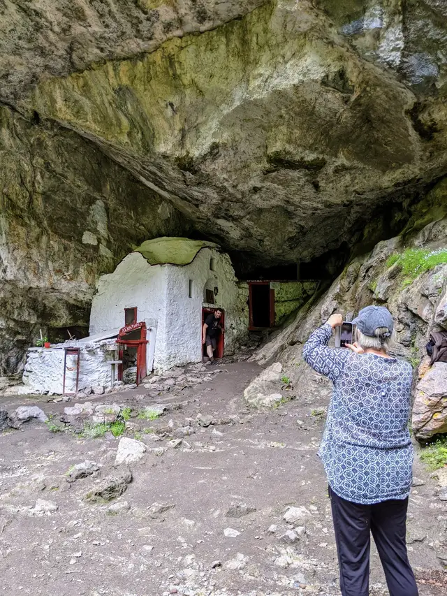 A guest photographs the old cave hermitage of Agios Dionysios on Mount Olympus during a Salty Soil day trip from Thessaloniki