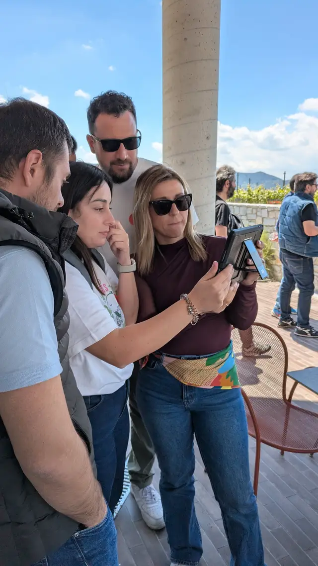 A team checks the tablet on a winery terrace during Operation Mindfall, a Salty Soil AR escape game played at a venue outside the city