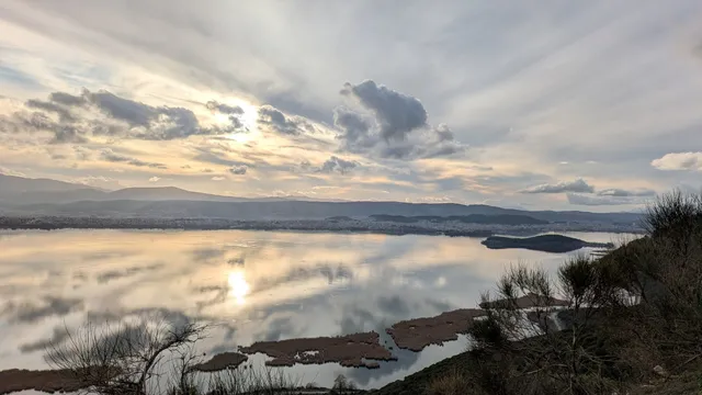 Lake Pamvotis and the city of Ioannina at sunset, seen from above on a Salty Soil private multi-day tour of Epirus