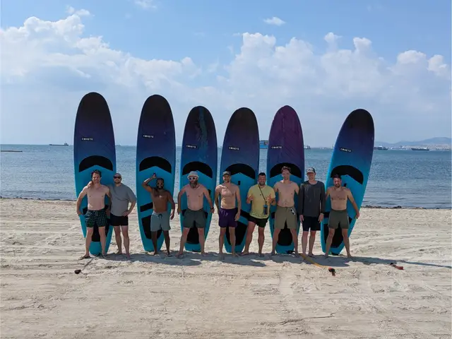 A group with their stand-up paddleboards on the beach at Perea, on a Salty Soil SUP tour near Thessaloniki