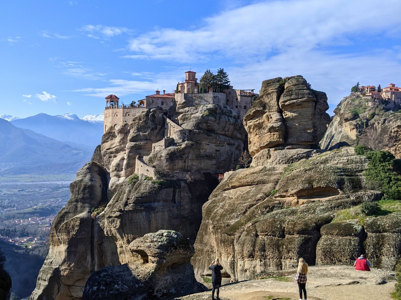 Monastery built on top of the rock formations of Meteora, with mountain views and blue sky in central Greece